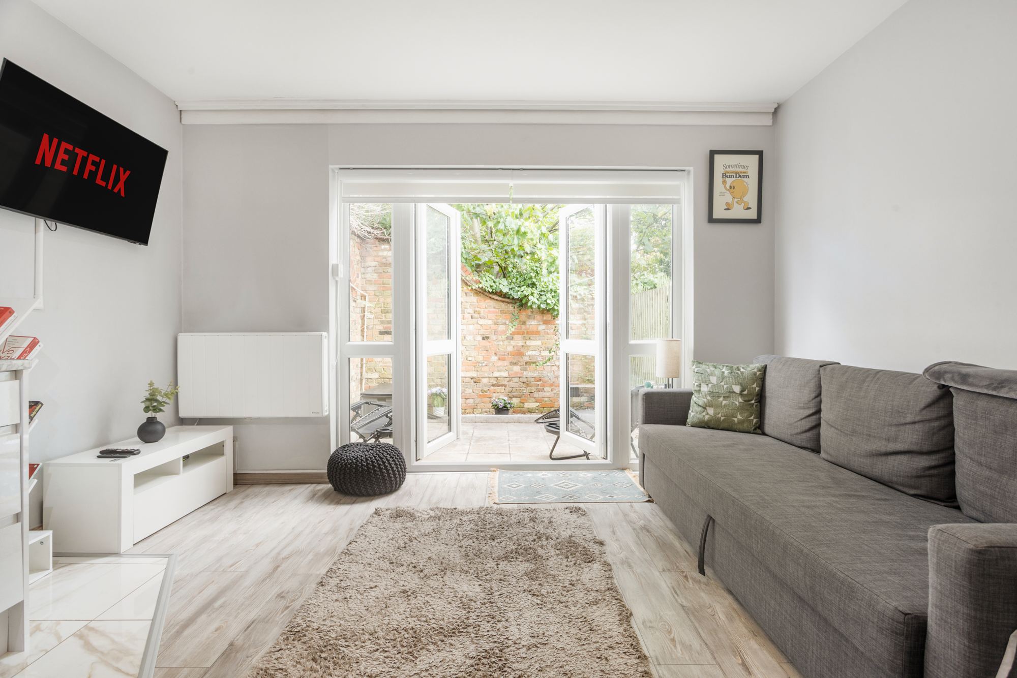 Living room with French doors open to the garden