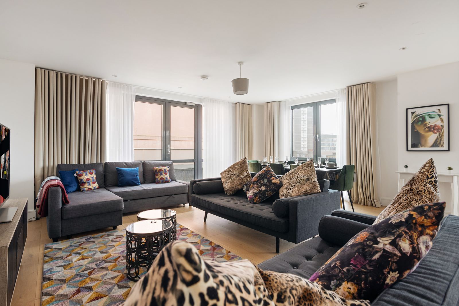 Living room with two sofas, patterned rug and dining area