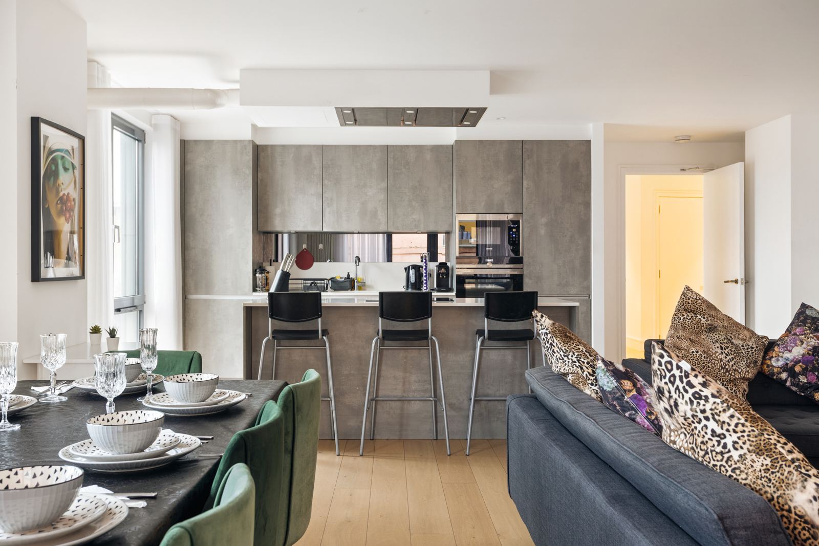 Dining table set for eight next to the kitchen