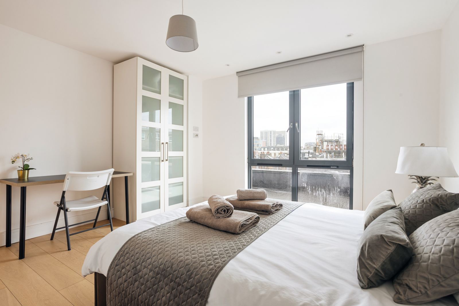 Bedroom with desk and rooftop view