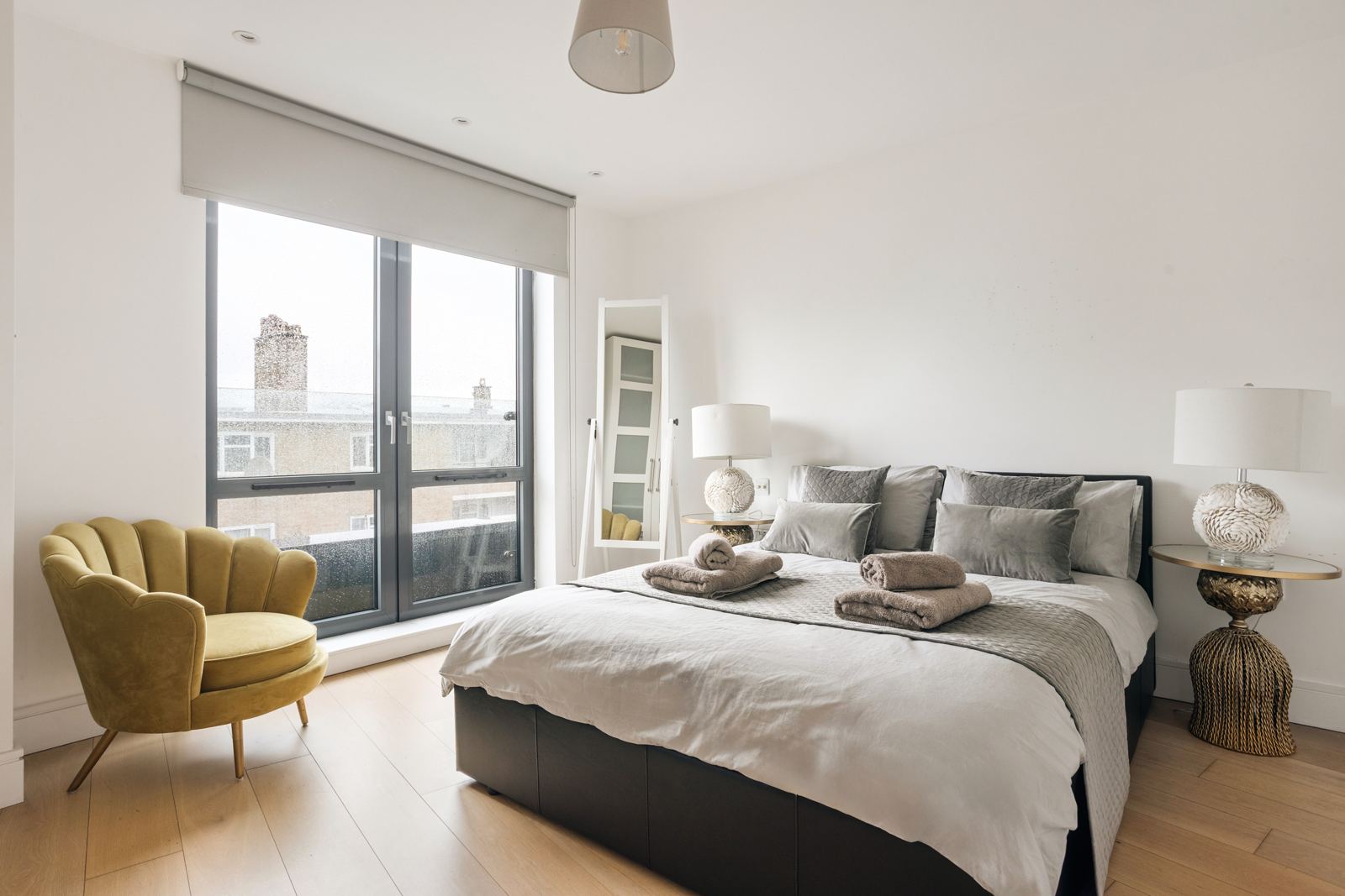 Bedroom with yellow velvet armchair