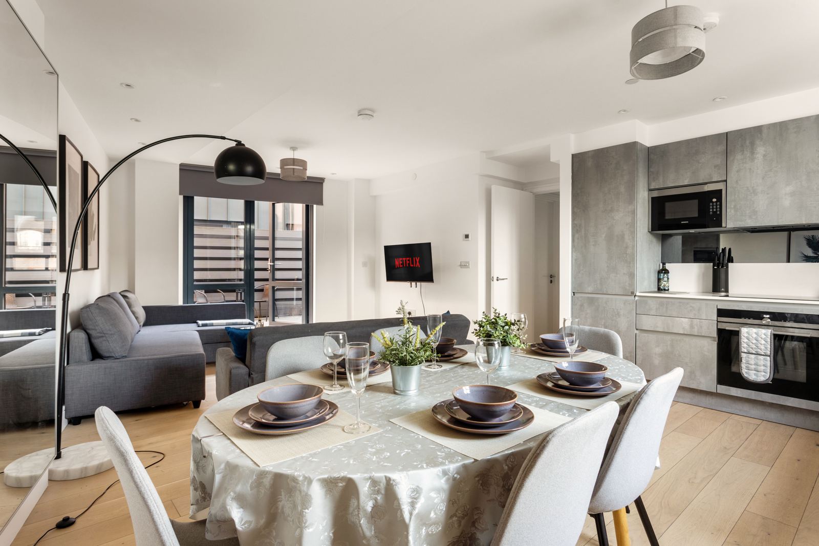 Dining table set for six beside the kitchen
